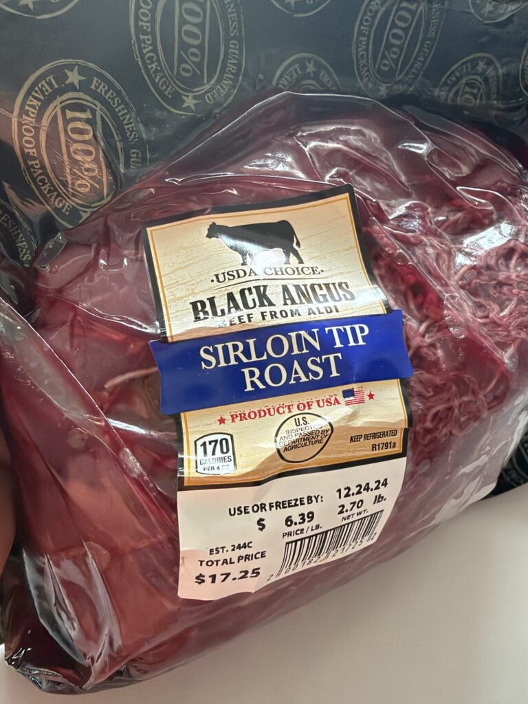 Aldi Black Angus sirloin tip roast in its original package with cooking netting visible.