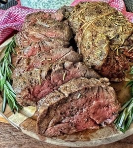 Beef tenderloin cut up with sprigs of rosemary and well seasoned