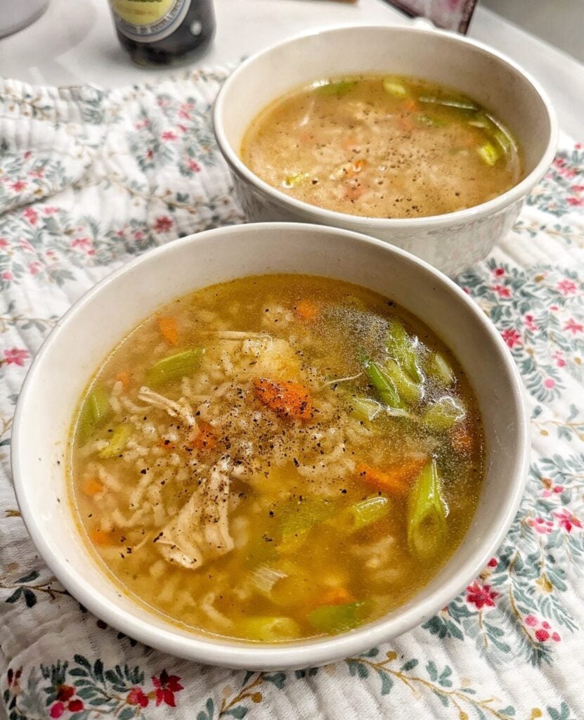 a bowl of chicken and rice soup with veggies
