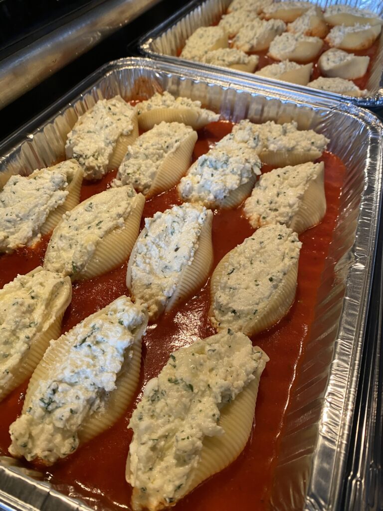 Jumbo pasta shells filled with cottage cheese mixture and arranged in marinara sauce