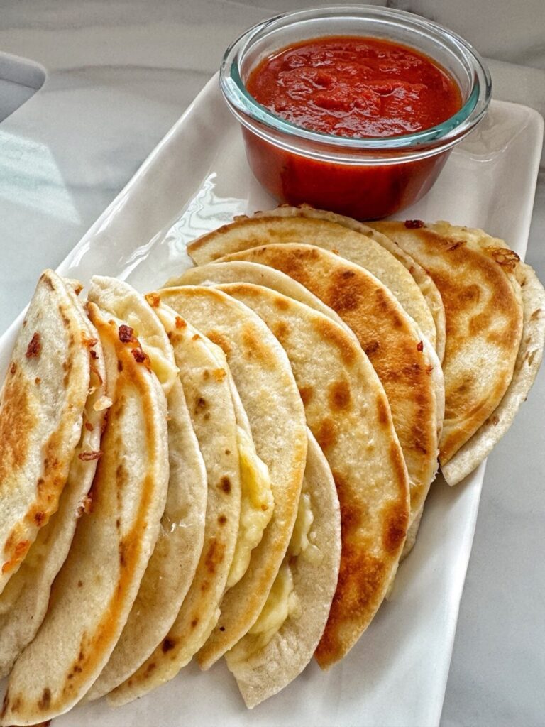 cheese quesadillas with a cup of warm salsa